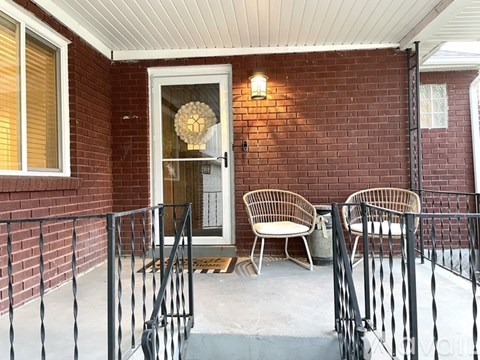 A patio with a chair and a table.