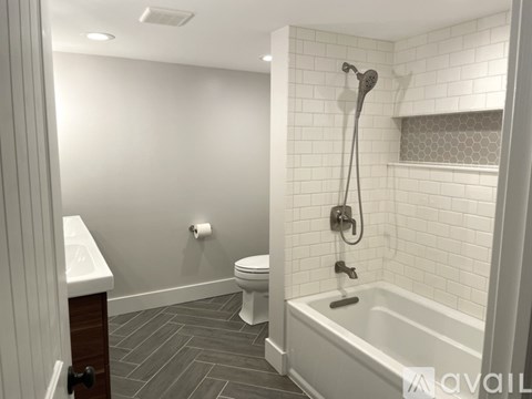 A bathroom with a toilet, sink, and bathtub.