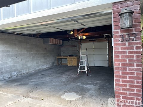 A garage with a ladder and a white door.