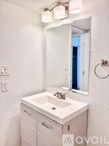 A bathroom with a sink and mirror.