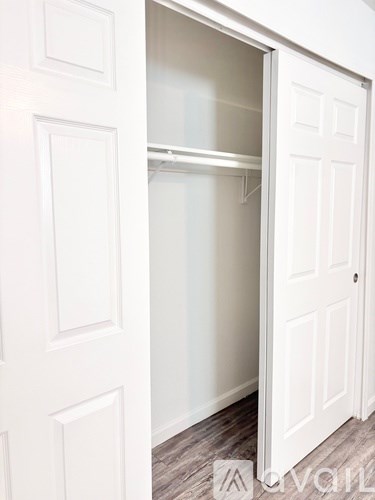 A white door is open to a white interior.