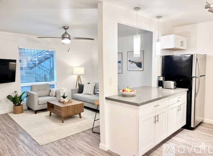 A modern kitchen with a dining area and a living room.