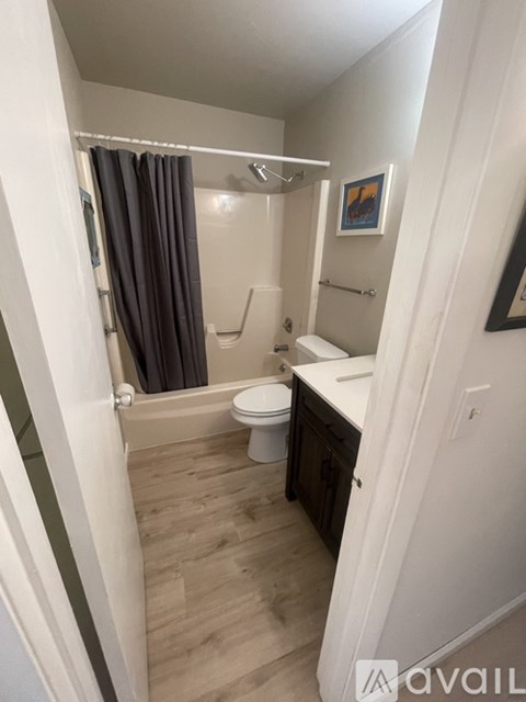 A bathroom with a toilet, sink, and shower.