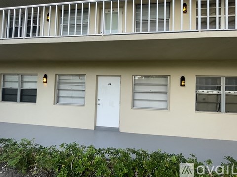 A white door is on the right side of a building.