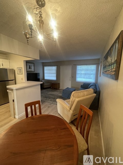 A dining room with a wooden table and chairs.