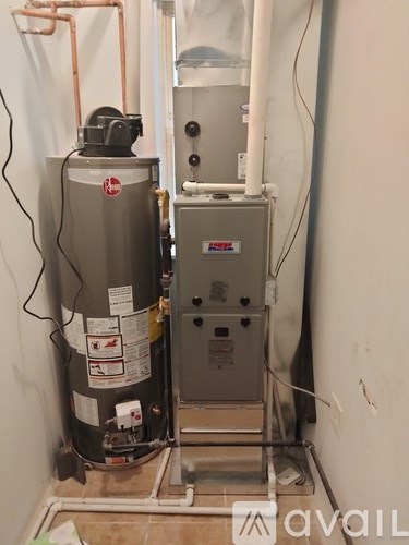 A water heater and a furnace are installed in a room.