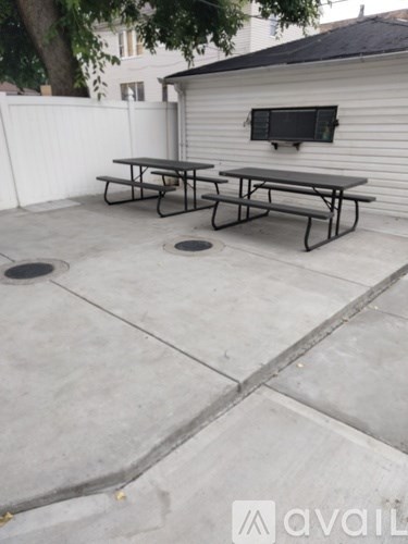 A patio with a table and two benches.