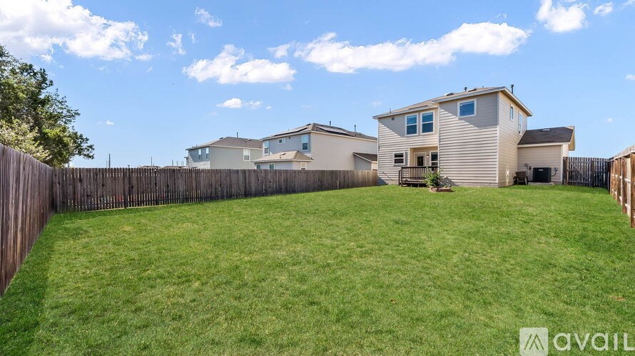 A house with a fence and a yard is for sale.
