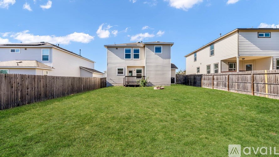 A row of houses with a grassy yard in the foreground.