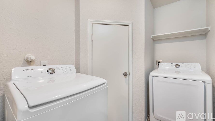 A white washing machine and dryer in a small laundry room.