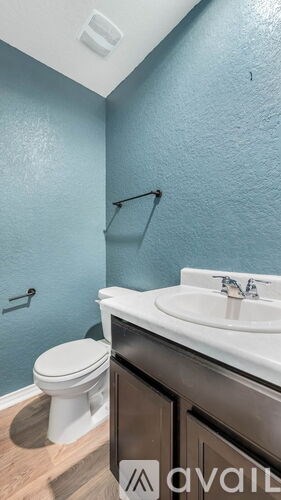 A bathroom with a toilet, sink, and shower.