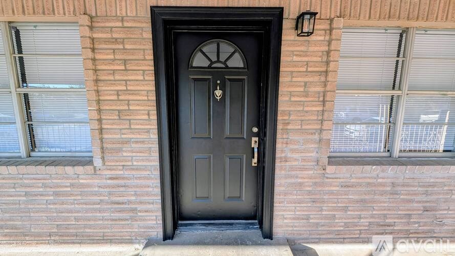 A black door with a glass window above it.