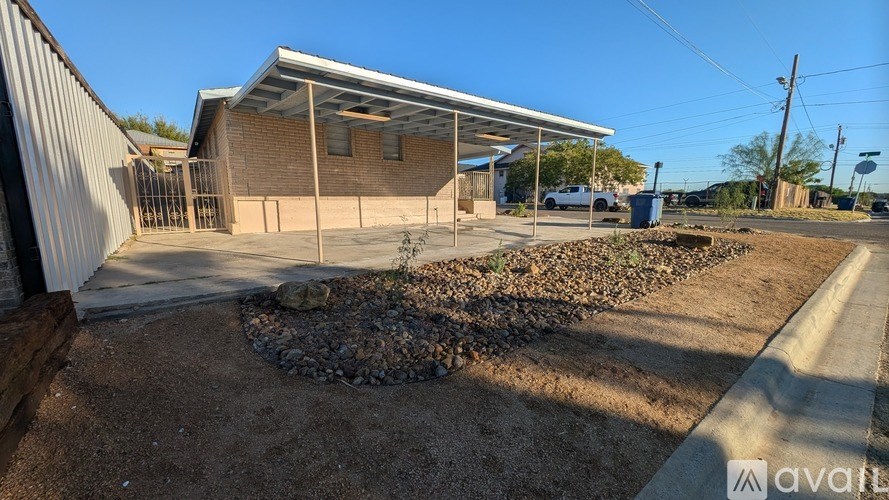 A building with a metal roof and a covered patio area.