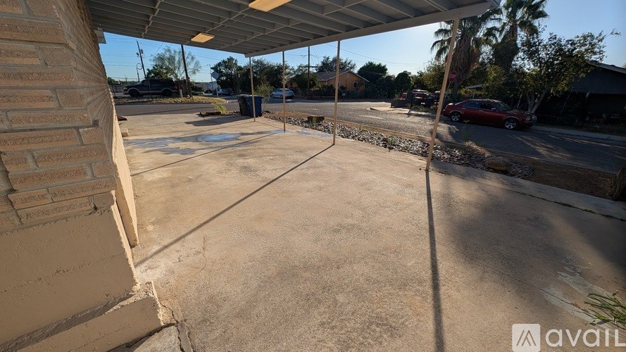 A parking lot with a car parked on the right side.