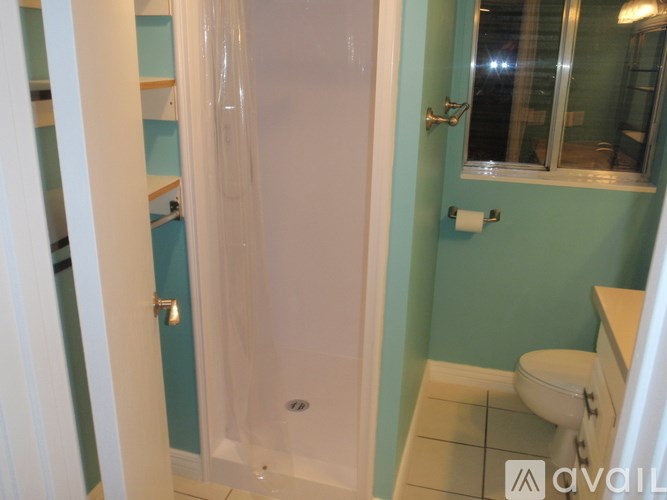 A bathroom with a toilet, sink, and shower.