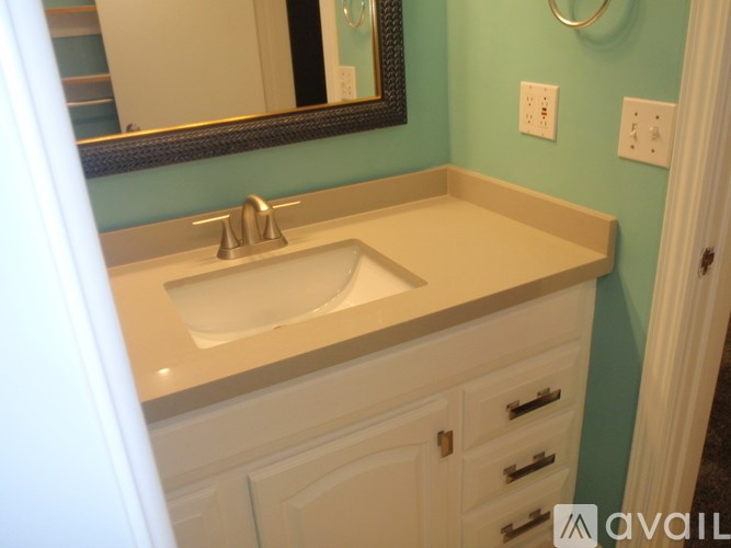 A bathroom with a sink and a mirror.