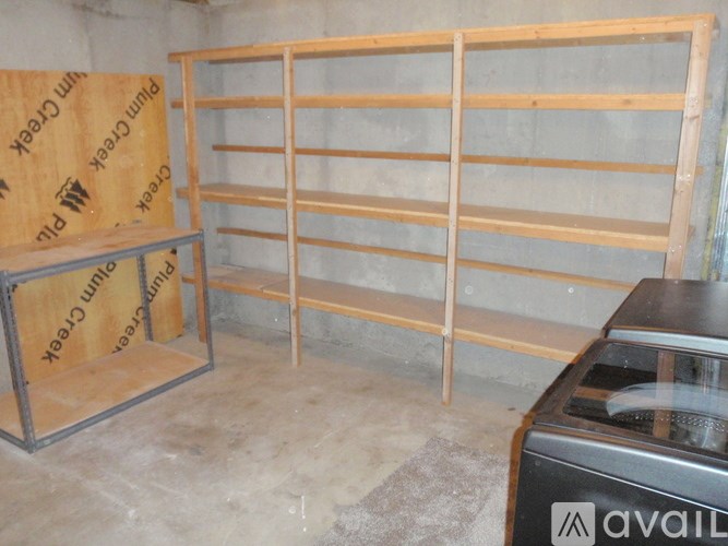 A wooden shelf with a metal frame and a box with the word "AVAILABLE" on it.