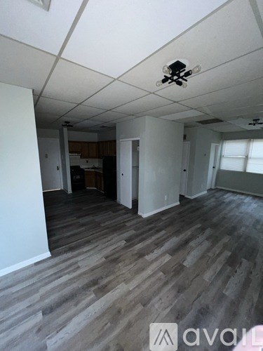 A room with wooden flooring and a ceiling fan.