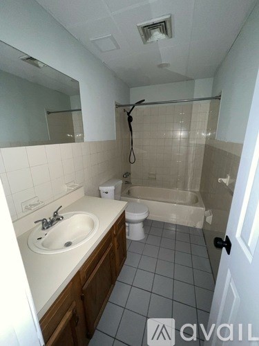 A bathroom with a sink, toilet, and bathtub.