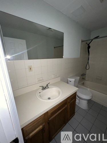 A bathroom with a sink, toilet and bathtub.