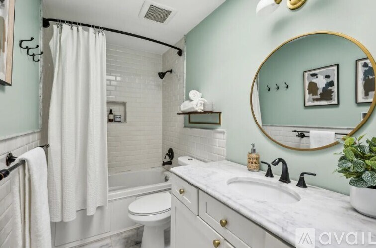 A bathroom with a white toilet, a white sink, and a white bathtub.