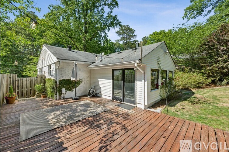 A house with a wooden deck in front of it.