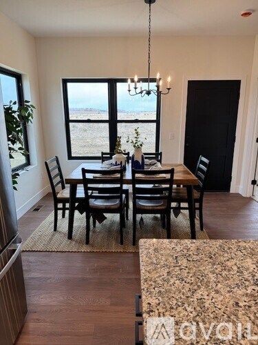 A dining room with a table set for six and a view of the beach.