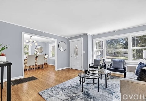 A living room with a glass table and a sofa.