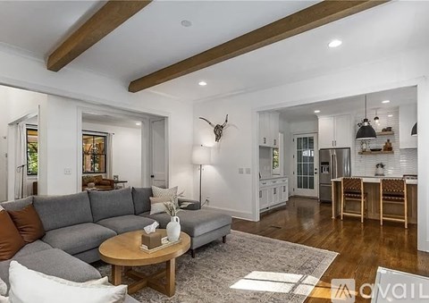 A living room with a grey sofa and a wooden coffee table.