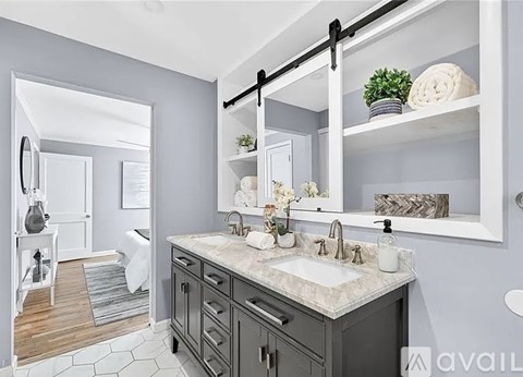 A bathroom with a sink, mirror, and shelves.