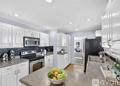 A kitchen with a bowl of fruit on the counter.