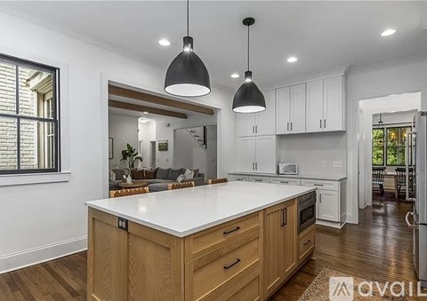A modern kitchen with wooden cabinets and a central island.