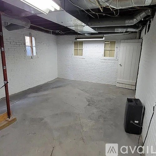 A room with white walls and a concrete floor.