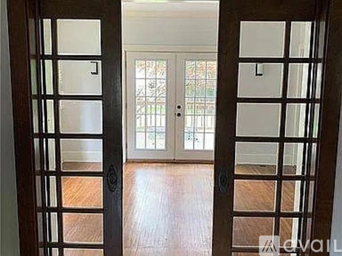 A room with a wooden floor and a glass door.