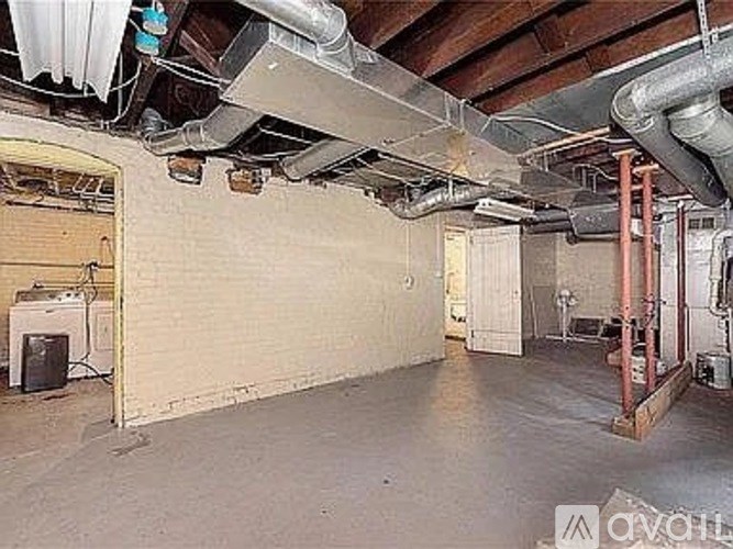 A room with a white wall and a door.