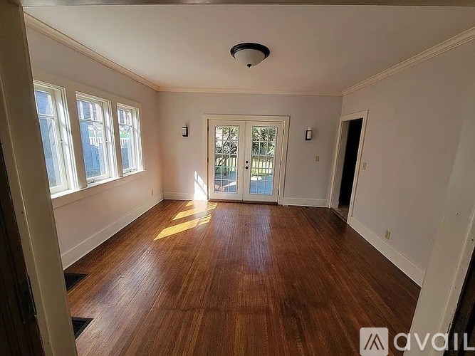 A room with wooden floors and a ceiling light.