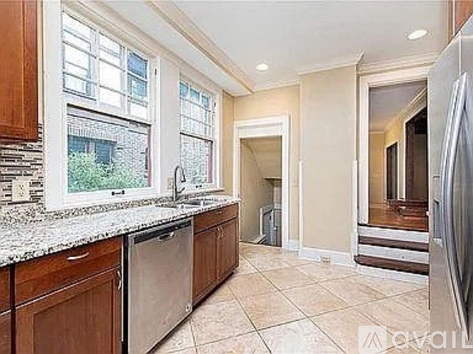 A kitchen with a dishwasher and a refrigerator.