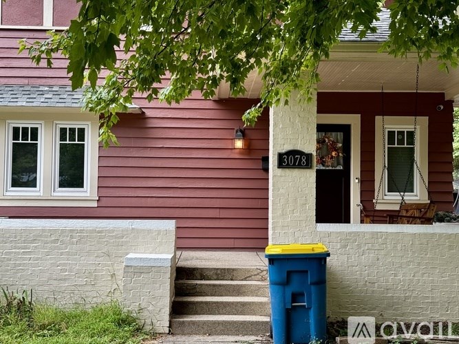 A red house with a white door and windows.