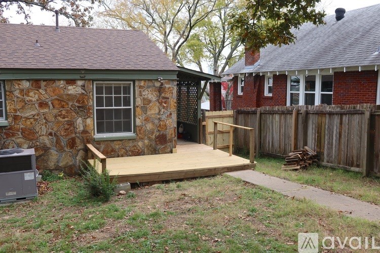 A stone house with a wooden deck in front.