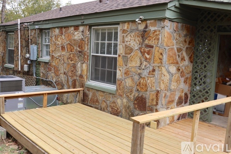 A stone house with a wooden deck.