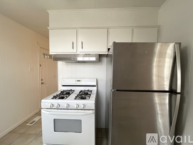 A kitchen with a stove and a refrigerator.
