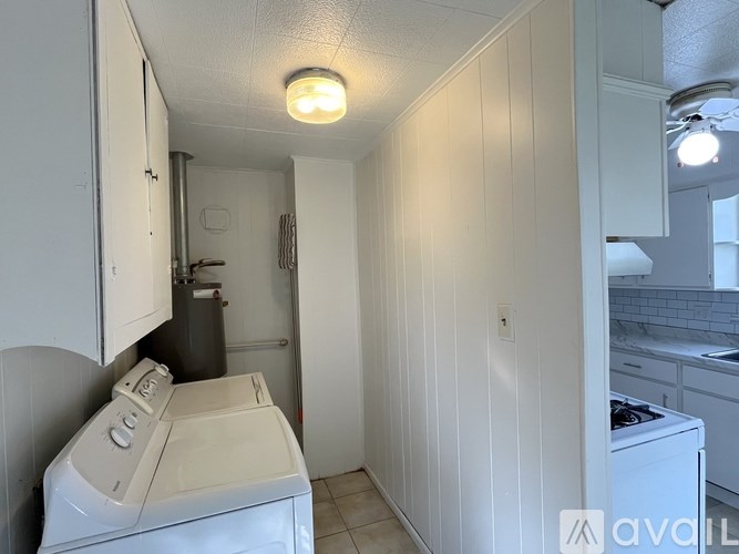 A small laundry room with a washer and dryer.
