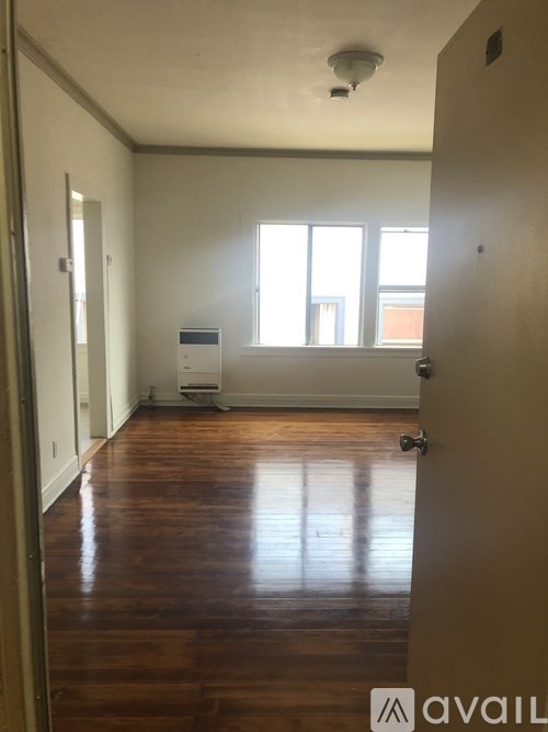 A room with wooden floors and a window.