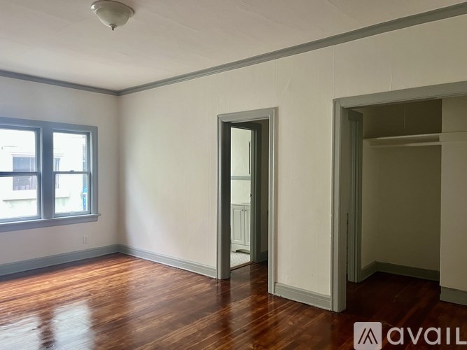 A room with wooden floors and white walls.