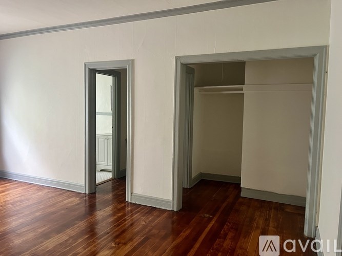 A white vanity with a mirror and drawers is in a room.