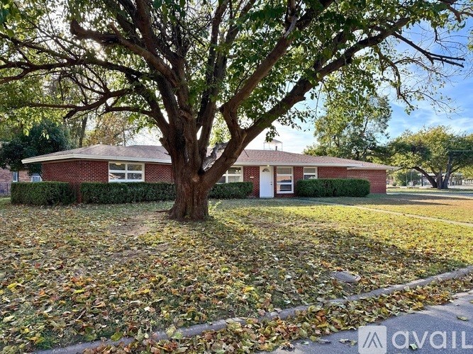 A house with a tree in front of it.