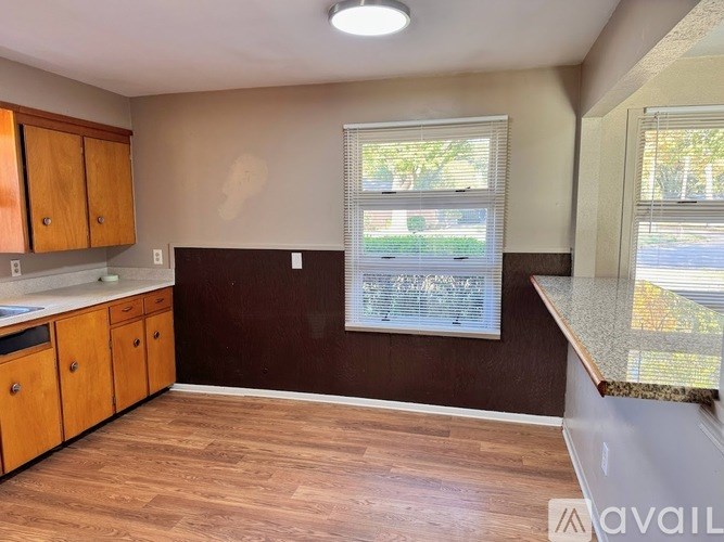 A kitchen with wooden cabinets and a countertop.