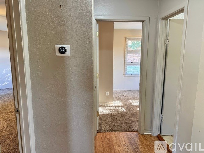 A white door with a black square on it.