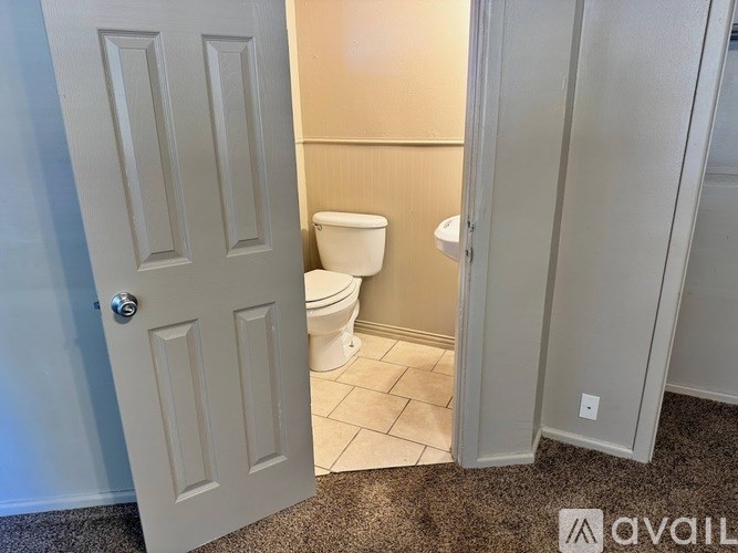 A bathroom with a toilet and a door.
