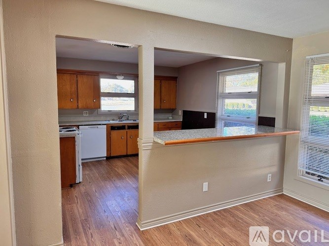 A kitchen with wooden cabinets and a countertop is shown.